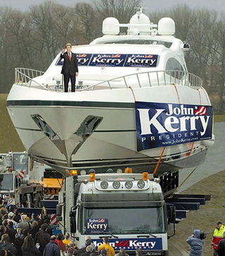 Kerry waves down to a crowd of supporters.